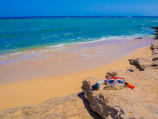 Fototapeta na wymiar Beautiful wild beach with turquoise water, orange sand and coral reef. Egypt, Marsa alam. Red sea