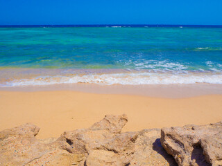 Beautiful wild beach with turquoise water, orange sand and coral reef. Egypt, Marsa alam. Red sea