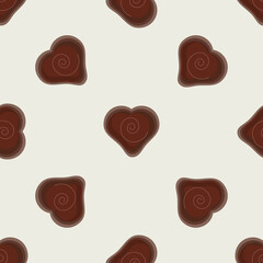 A pattern of chocolate hearts on a beige background