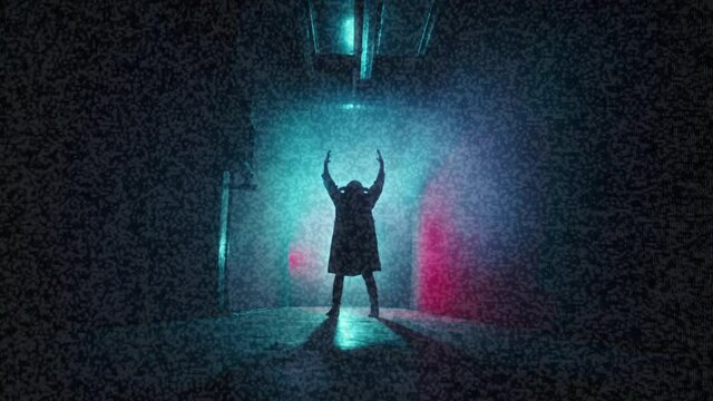 Old tv screen showing devil with glitch effect. Exorcist with horns putting hands up, standing in dark corridor, horror film concept. Haunted house movie, video clip with ghost. 