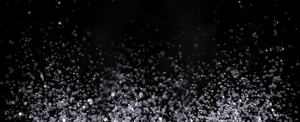 air bubbles in the water isolated on black background