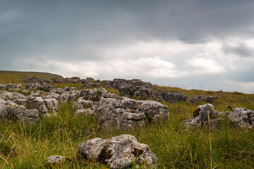 Fototapeta na wymiar A cloudy late summer 3 shot HDR image of Limestone pavement on Orton Fell, above Orton, in Cumbria, England. 