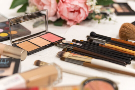 A set of brushes and professional cosmetics on the makeup artist's desk. Everything for applying makeup. Suitable for your beauty blog. Make up the most necessary things. Flatly. Soft focus.