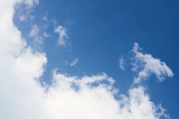 Cloud in the sky closeup over clear blue sky diagonal composition with copyspace.