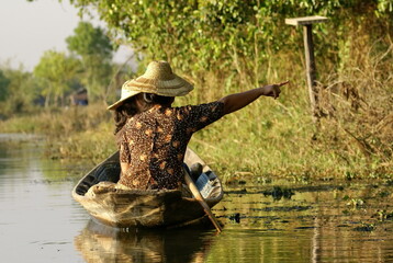 Burmese people paddling on a canal in Nyaungshwe, Myanmar