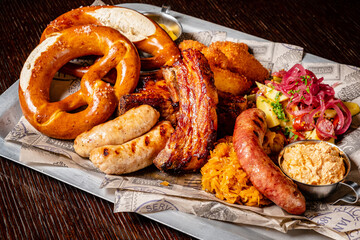 Oktoberfest beer menu germany traditional rustic style, veal pretzel, sausage with mustard in white plate on wooden rustic table.