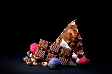 Chocolates background. Chocolate. Assortment of fine chocolates in white, dark, and milk chocolate. Praline Chocolate sweets
