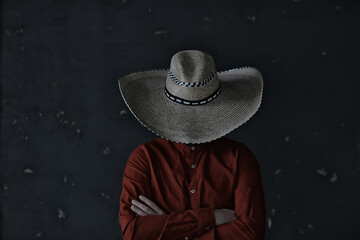 man in a hat with straw brim, hides his face, incognito guy, abstract country music style america...