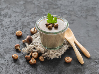 Mushroom dish, yellow boletus pate pudding in glass on a linen napkin on a dark gray background