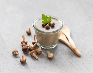 Mushroom appetizer, pate pudding  in glass on a light gray background