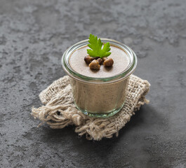 Mushroom pudding in glass on a dark gray background