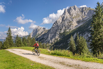 beautiful active senior woman with electric mountainbike in the spectacular Mountains of Raintal...