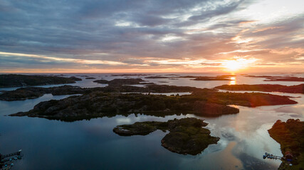 Fototapeta premium Sunset at the Swedish archipelago in Bohuslän with clouds in the sky - Drone Perspective Landscape Photography
