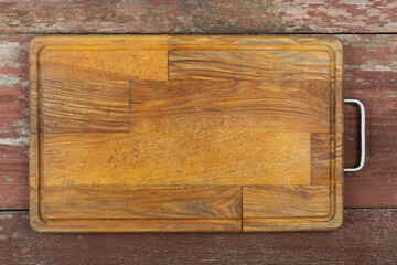 Empty cutting board on a wooden table. Space for text.