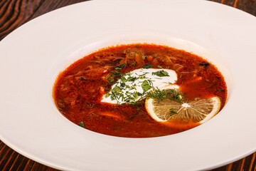 Russian traditional Solyanka soup with sausages