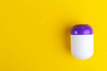 Deodorant on a yellow background. Space for text.