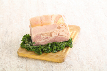 Cut of pork bacon over board