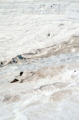 Pamukkale travertine texture. Wavy limestone textured deposits on terraces of carbonate minerals in Pamukkale, Turkey.