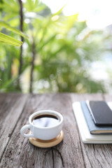 Coffee and notebooks on wooden table
