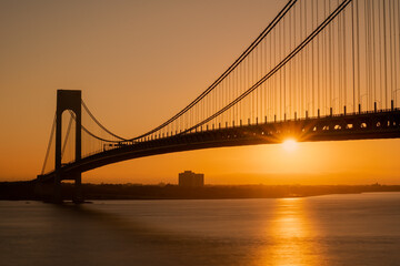 Fototapeta na wymiar Staten Island, NY - USA - Sept. 18th 2021: A landscape view of the Verrazzano-Narrows Bridge,seen from Fort Wadsworth in the Gateway National Recreation Area during the golden hour.