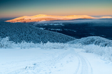 A view from the top of Wielka Rawka to the Bieszczady peaks at sunset, the Bieszczady Mountains