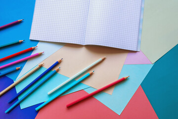 School and hobby concepts. Colored paper sheets, colored pencils and notebooks. Copy space