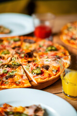tasty pizza on the wooden background
