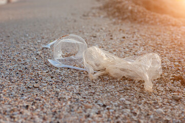 Plastic and plastic bag, trash on the background of a sandy beach