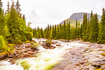 Fast flowing river water of beautiful waterfall Rjukandefossen Hemsedal Norway.