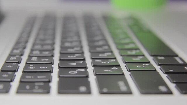 Computer work: Hands are typing on a macbook keyboard. Close-up
