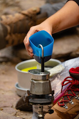 a person making coffee during hiking