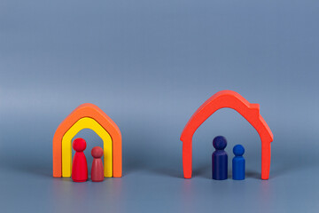Divorce, conflict between parents, children custody, property division. Miniature figures of father with son and mother with daughter in small wooden houses after divorce - obrazy, fototapety, plakaty
