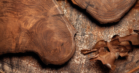 Solid oak cutting board and pine tree bark on rust metal background