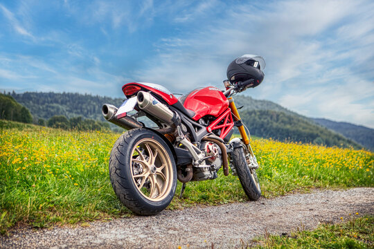A ducati monster motorbike on a dirt road off-roads