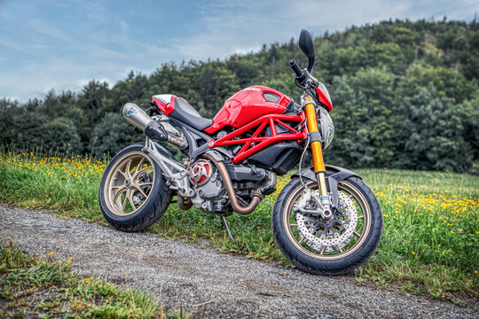 A ducati monster motorbike on a dirt road off-roads