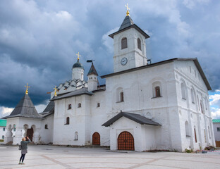 tourist woman near Church of the Intercession of the Blessed Virgin in Holy Trinity Alexander...