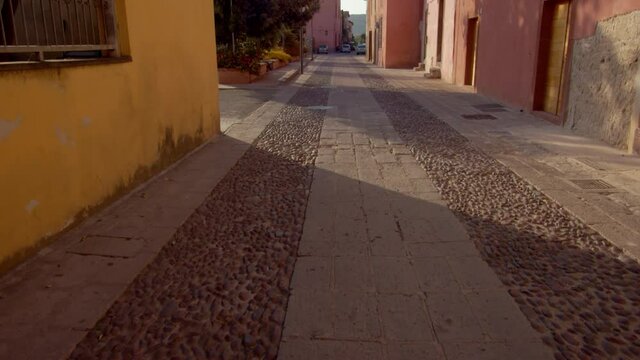 An alleyway through the olf colorful buildings in a small town in 4K