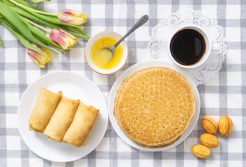 Russian pancakes stuffed with cottage cheese, stack of pancakes with syrup