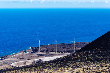Wind farm near the coast amidst volcanic landscape in the Island of La Palma, one of the Canary...
