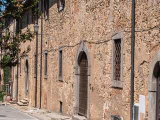 External Wall with Doors and Windows of an Ancient House in the Italian Medieval Village called Bolgheri in Tuscany