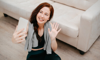 Young athlete conducts an online broadcast of yoga and meditation lessons by phone.Concept of...