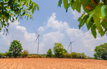 white windmill with blue sky and green environment, Single wind turbine to generate electricity for...