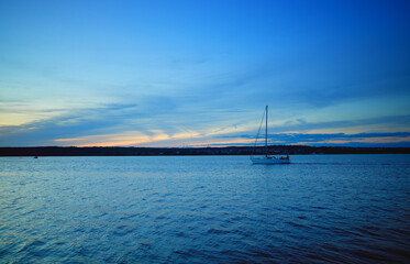 Boat on sunset river background