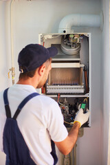 The master engineer maintains the gas heater. Adjusts the combustion of gas in the equipment