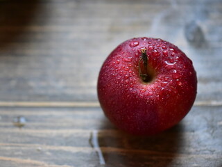 red apple on wooden table