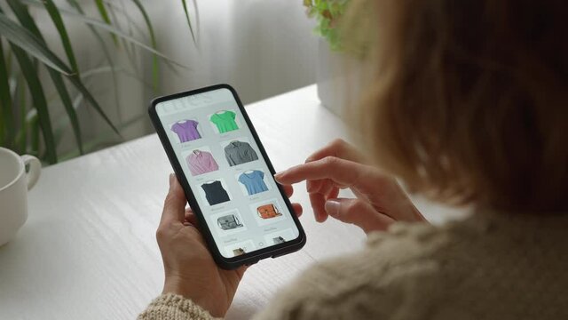 Woman using smartphone, shopping online. E-commerce using a mobile phone.