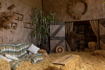 hay bales and pillows. rustic style area. jugs for milk on a haystack. straw