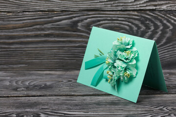 Homemade handmade postcard. On black pine boards.