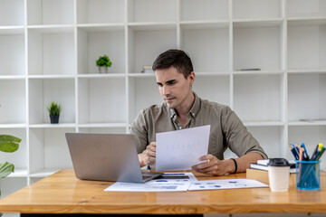 Fototapeta premium A young businessman is discussing a laptop video conference with a business partner who founded a startup company together, they have a company finance meeting to fix and plan financial arrangements.