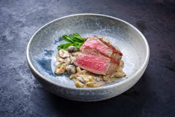 Modern style traditional barbecue dry aged angus roast beef steak natural with mushrooms and onions...